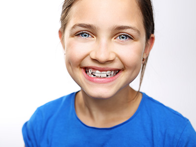 A young girl with a bright smile, looking directly at the camera.